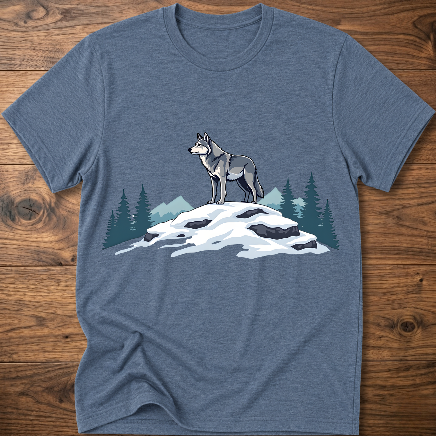 Heather indigo t-shirt with standing wolf graphic over snowy rocks and pine trees