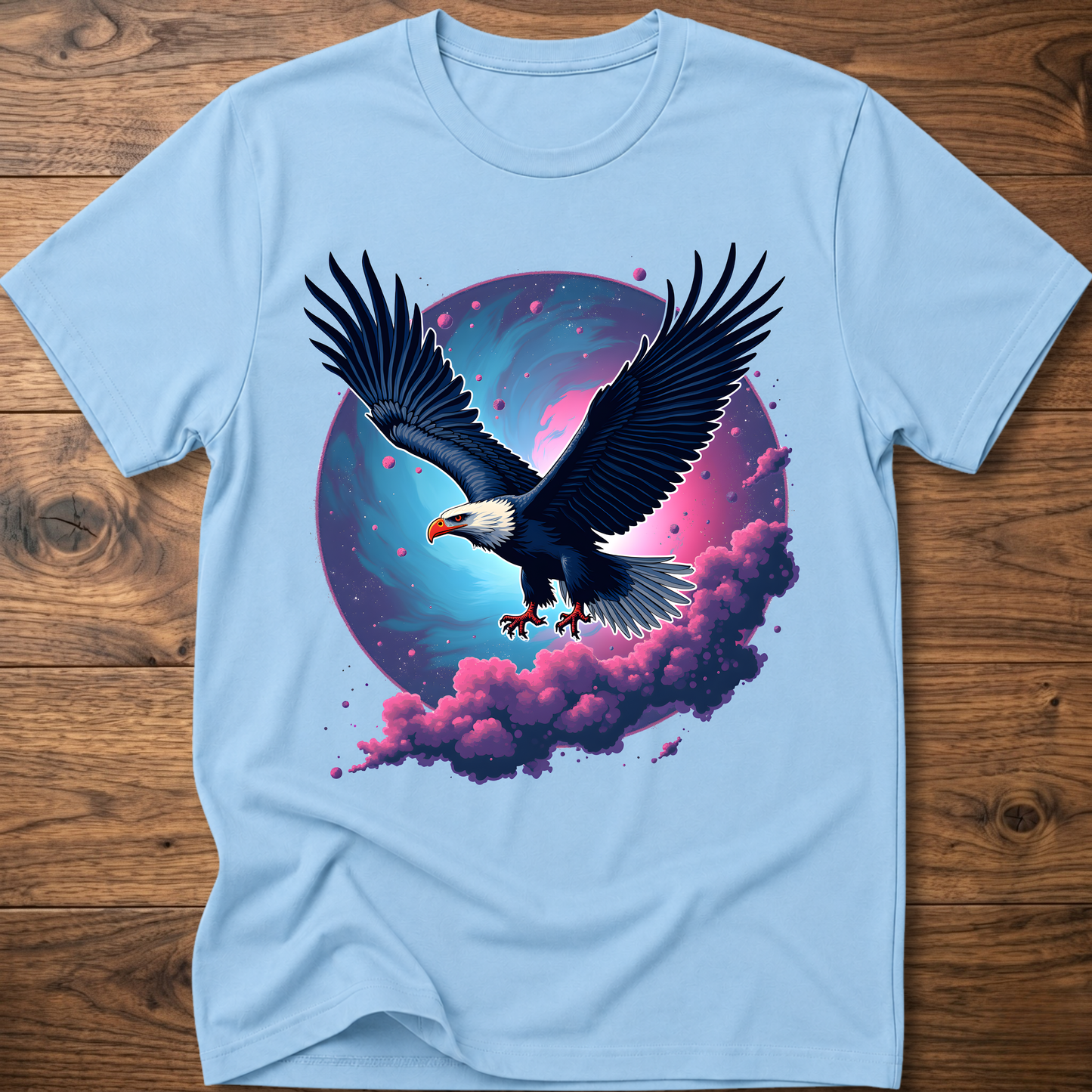 Light blue eagle T-shirt with galaxy wing art and pink-purple clouds on front