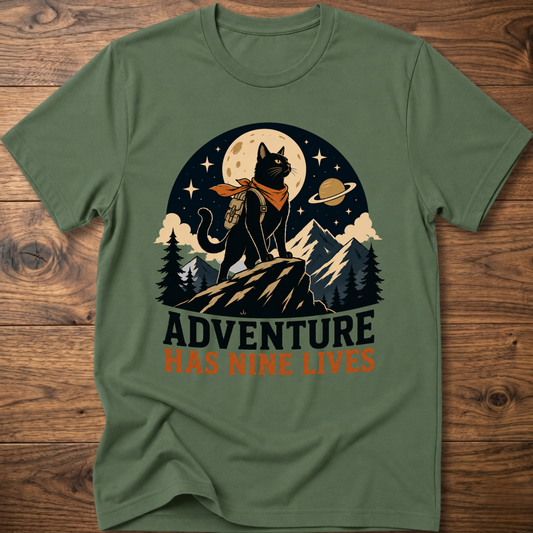 Military green cat graphic t-shirt, moonlit cat on mountains with 'Adventure Has Nine Lives'