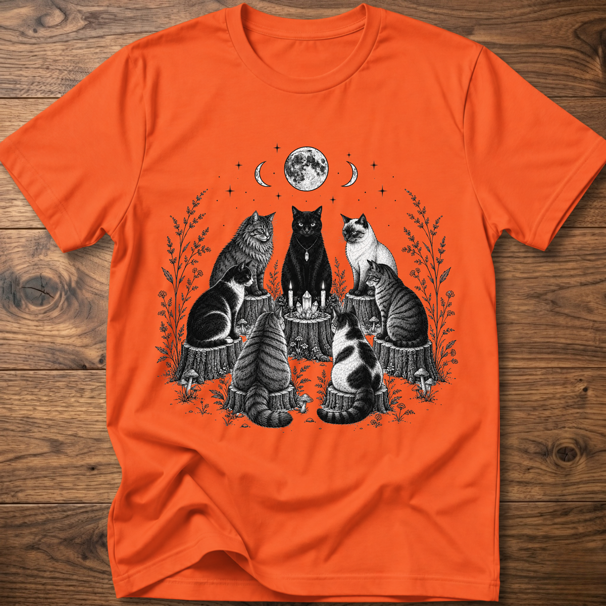 Orange t-shirt with moonlit cat coven graphic: cats around candles, crew neck short sleeves