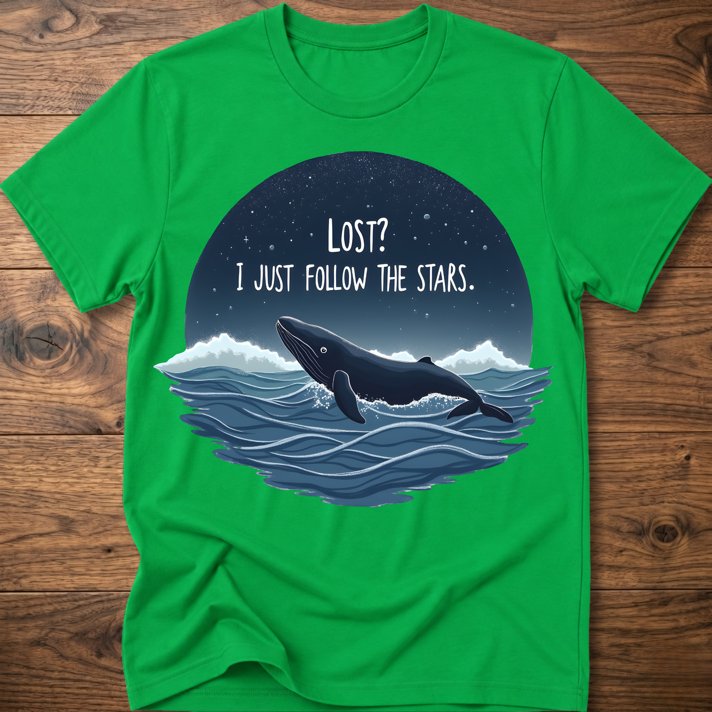 Green whale graphic t-shirt with circular “LOST? I JUST FOLLOW THE STARS.” print
