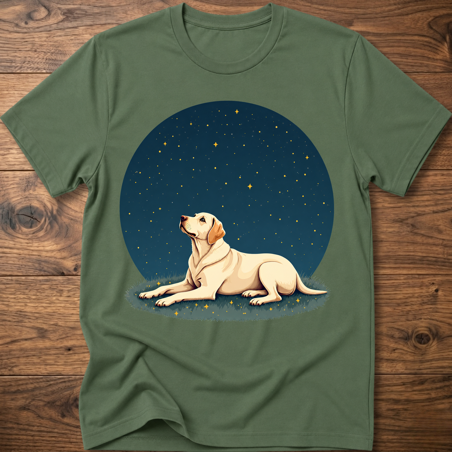 Green t-shirt with starry sky circle graphic and tan dog lying on grass