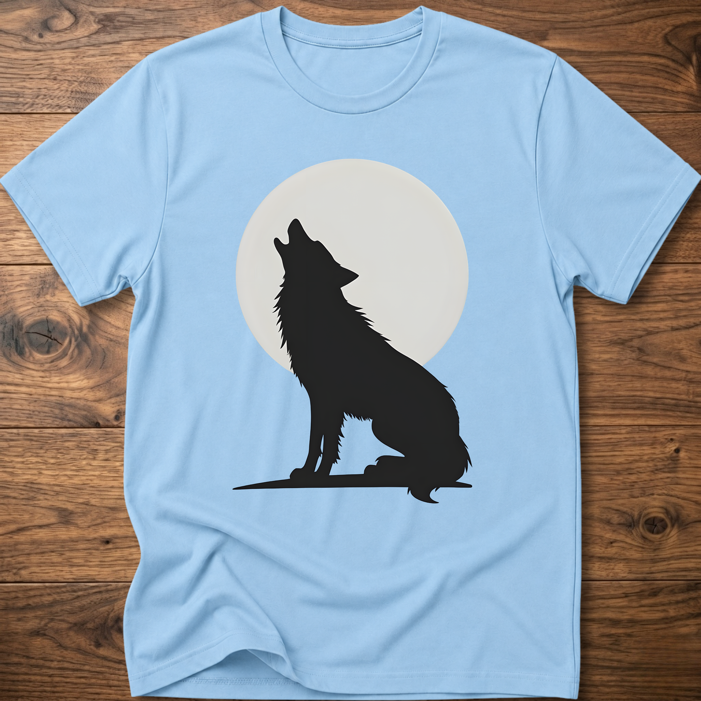 Light blue graphic wolf T-shirt with black wolf silhouette and white moon circle print.