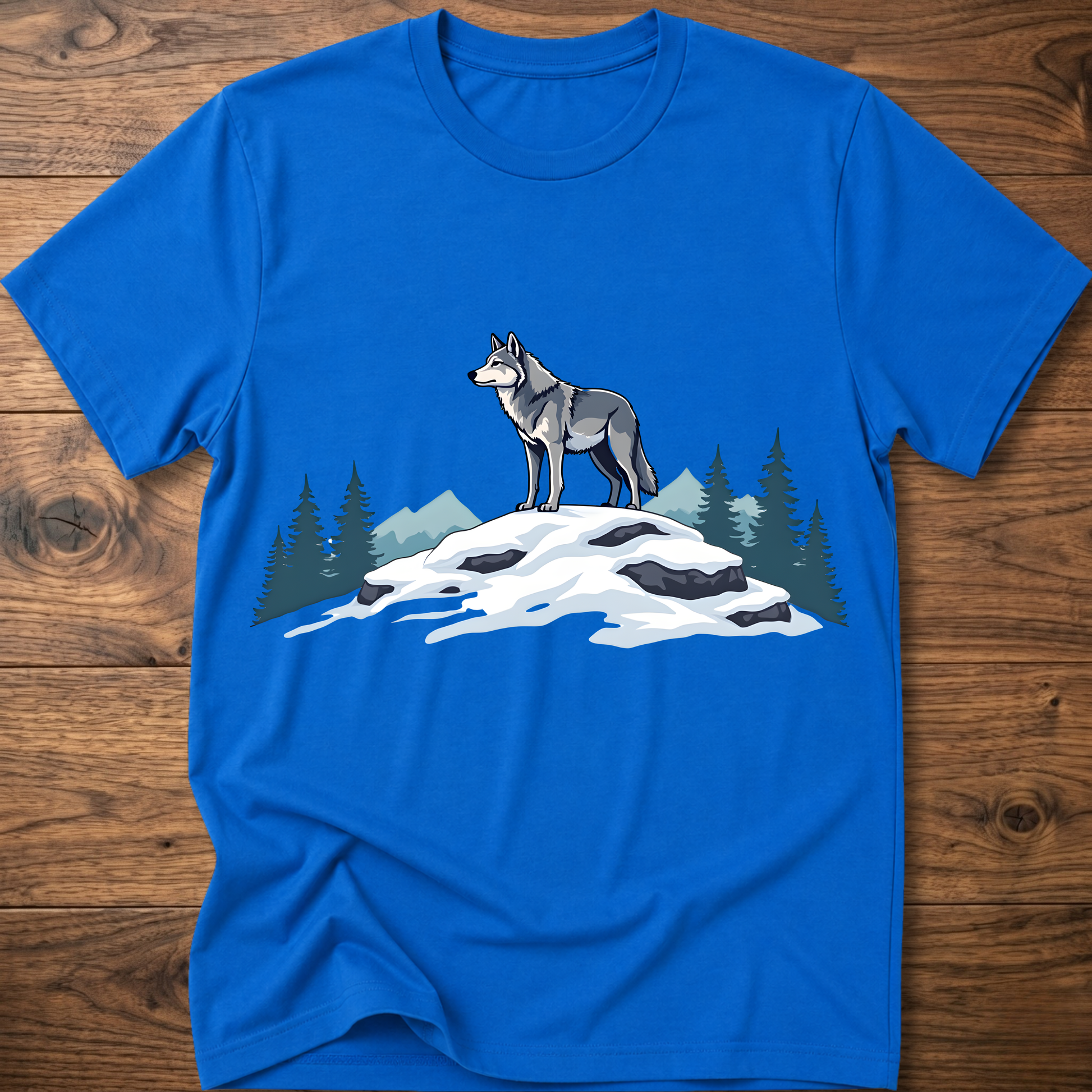 Royal blue t-shirt with standing wolf graphic over snowy rocks and pine trees