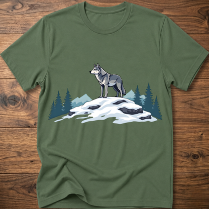 Military green t-shirt with standing wolf graphic over snowy rocks and pine trees