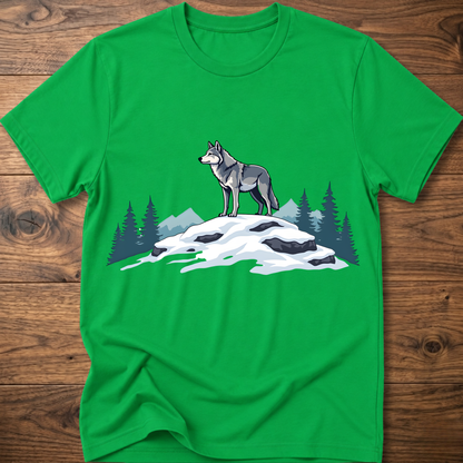 Green t-shirt with standing wolf graphic over snowy rocks and pine trees