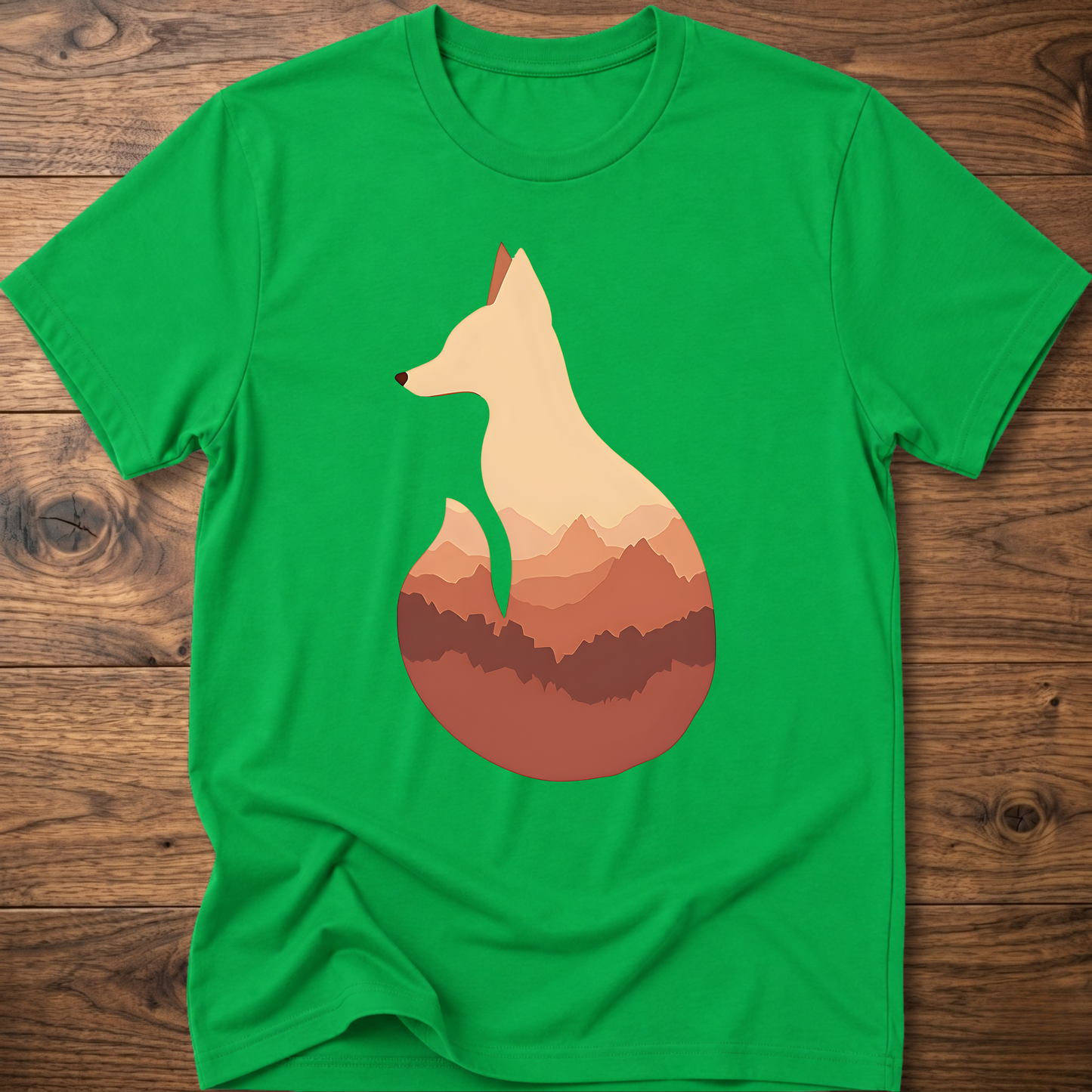 Irish green t-shirt with cream fox silhouette graphic over sunset mountains