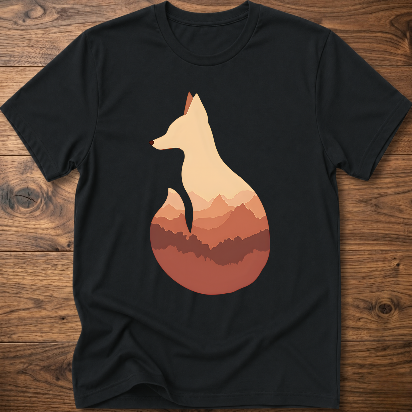 Black t-shirt with cream fox silhouette graphic over sunset mountains