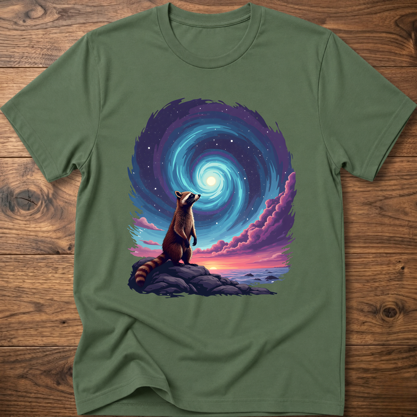 Green crew-neck t-shirt with raccoon sitting before blue-purple galaxy swirl graphic