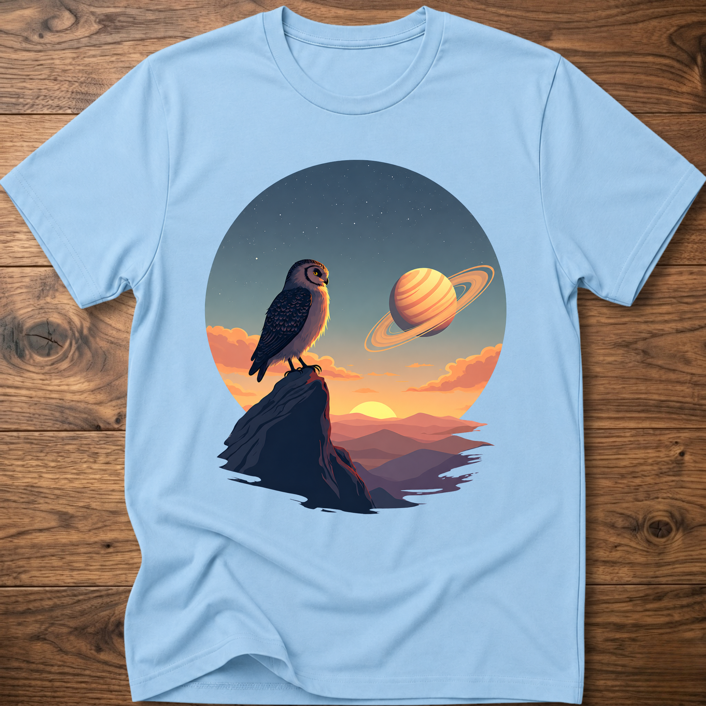 Light blue t-shirt with owl and Saturn planet scene graphic on front