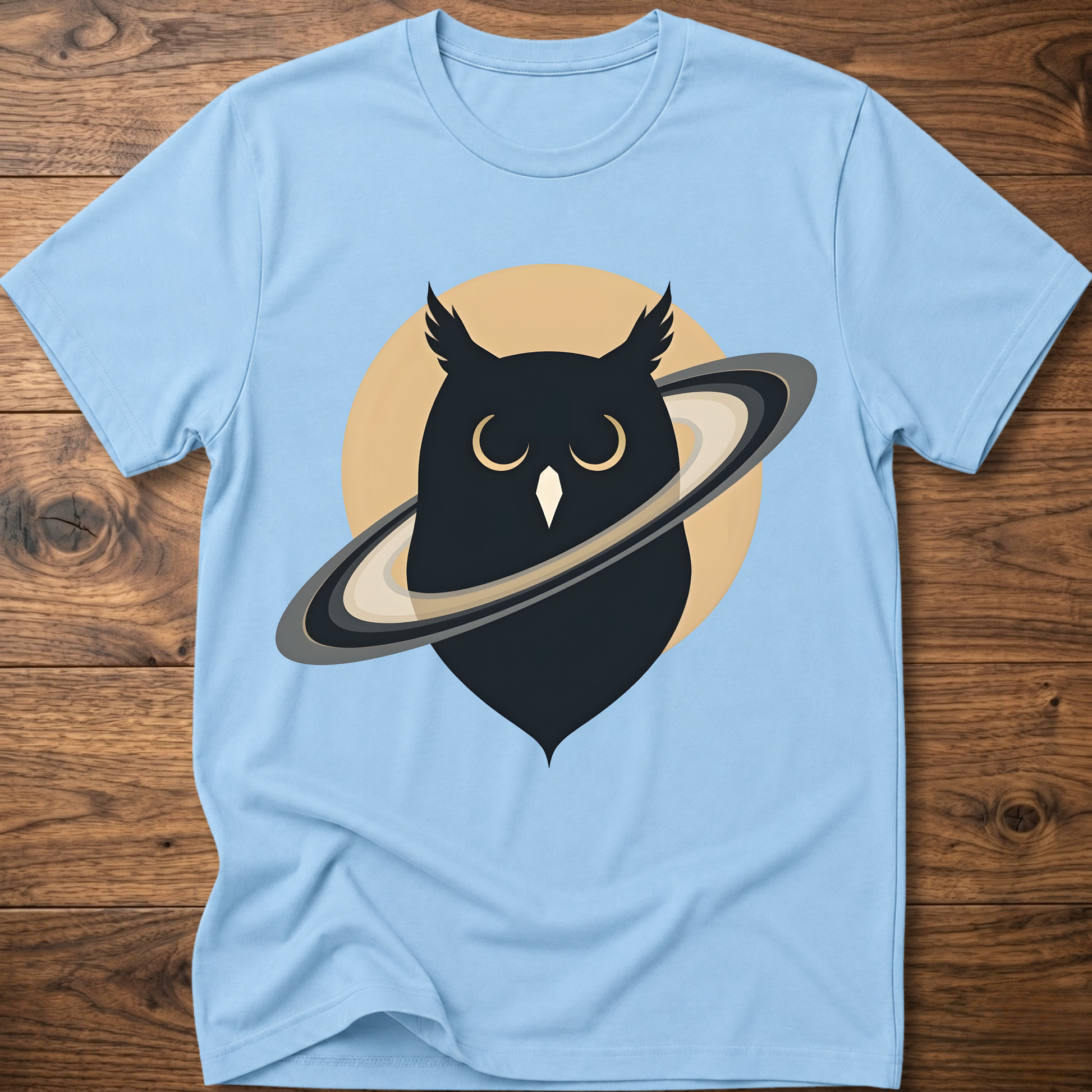 Light blue t-shirt with black owl and planet graphic on the front