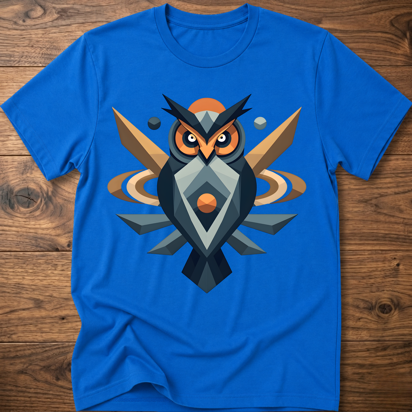 Royal blue t-shirt with geometric owl graphic in dark blue, tan, and orange.