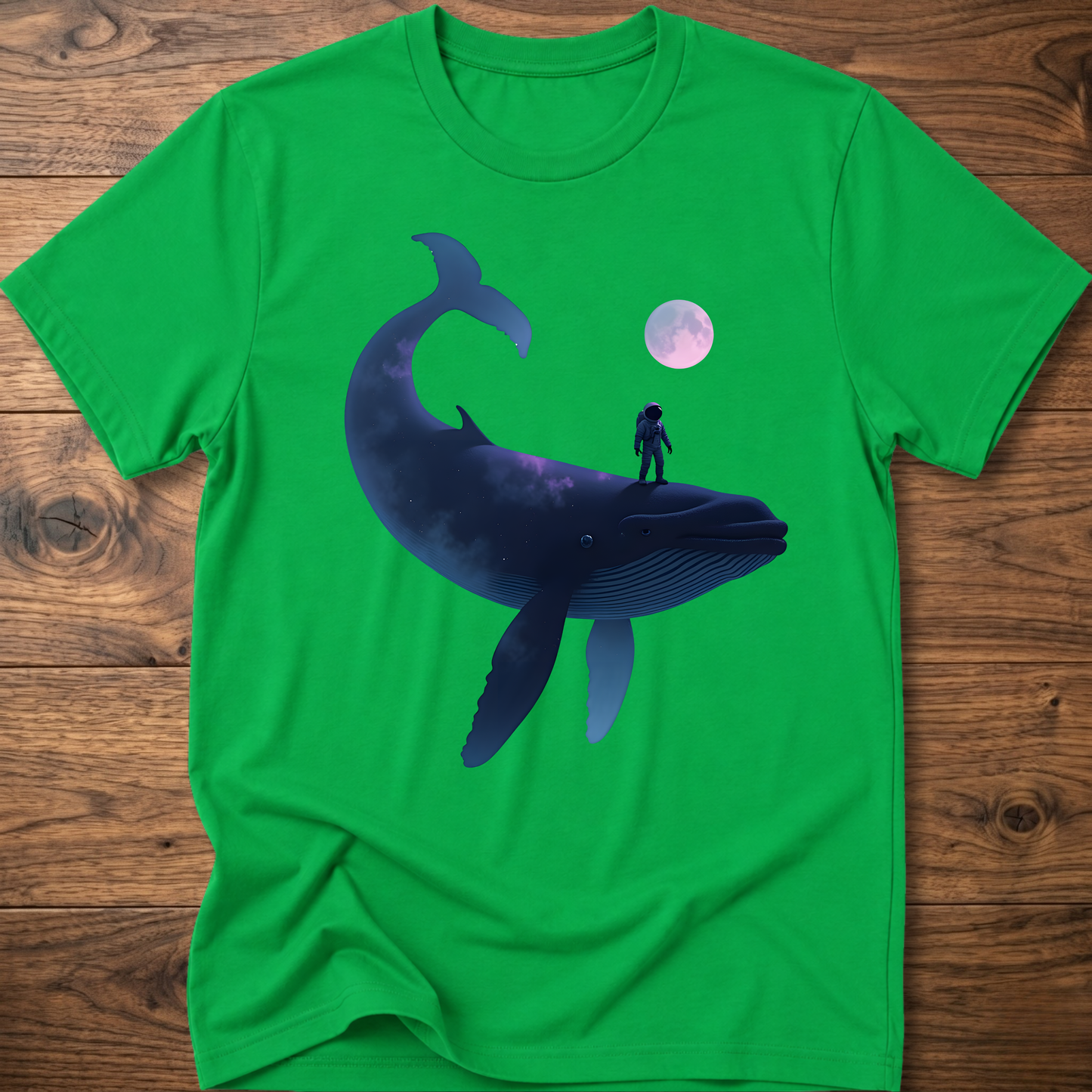 Green T-shirt with astronaut riding dark whale graphic and small planet print