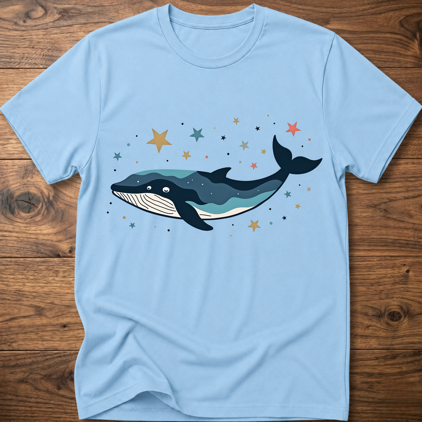 Light blue whale graphic t-shirt with colorful starry constellation print