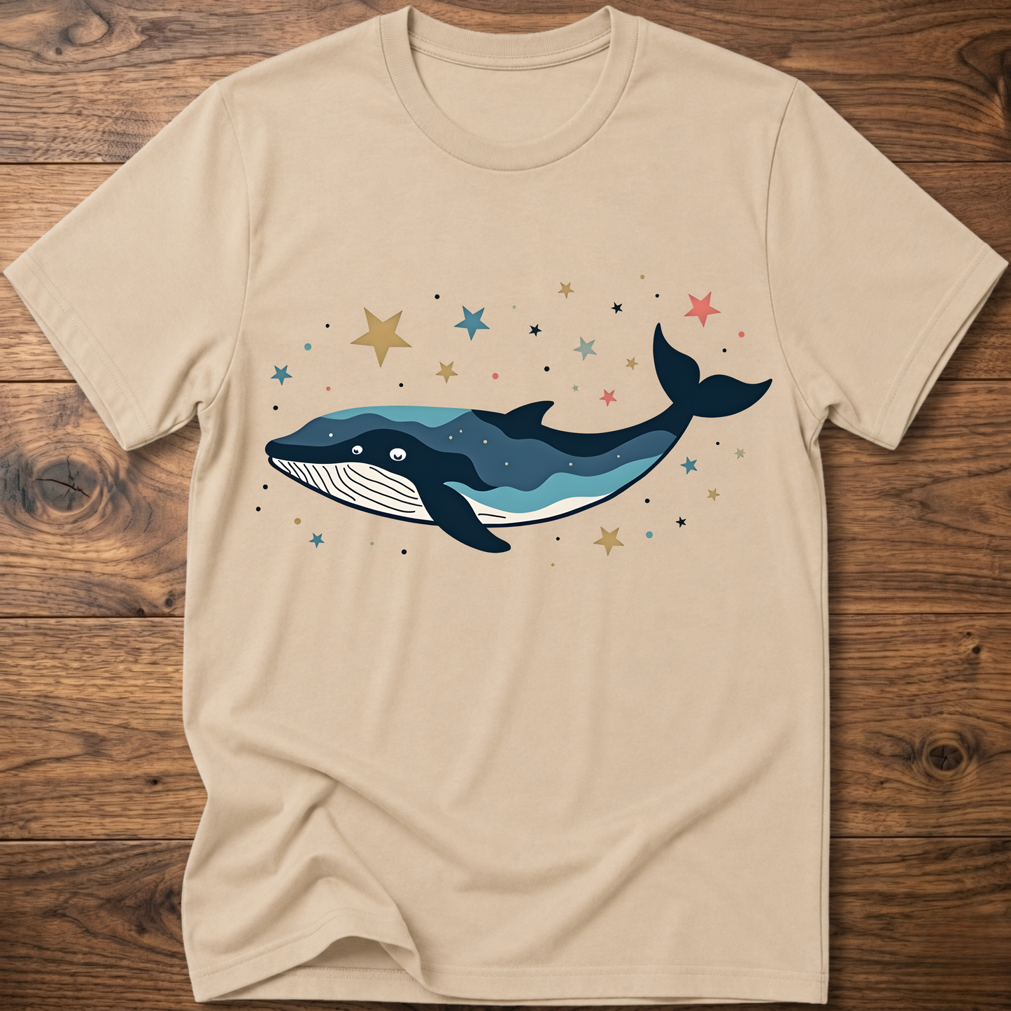 Beige whale graphic t-shirt with colorful starry constellation print