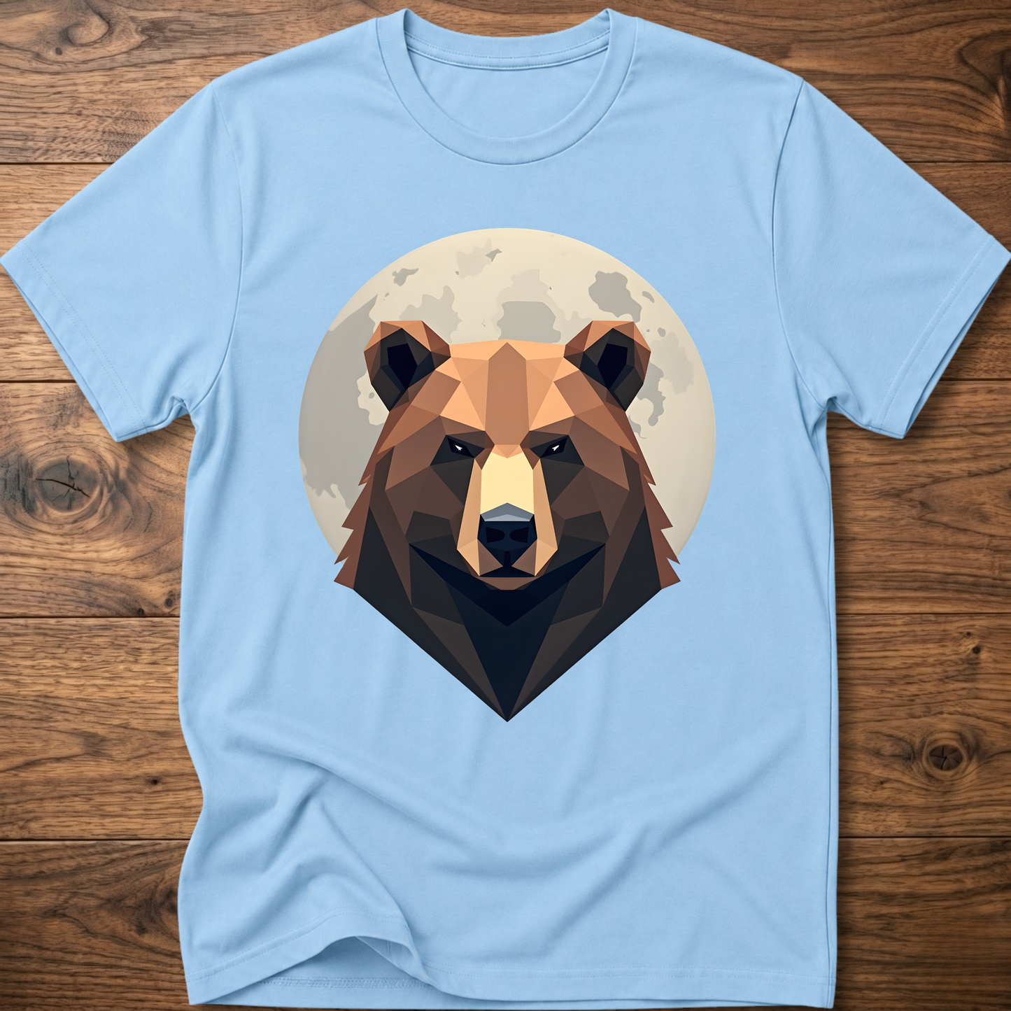 Light blue T-shirt with centered geometric bear head graphic inside a moon-like circle.