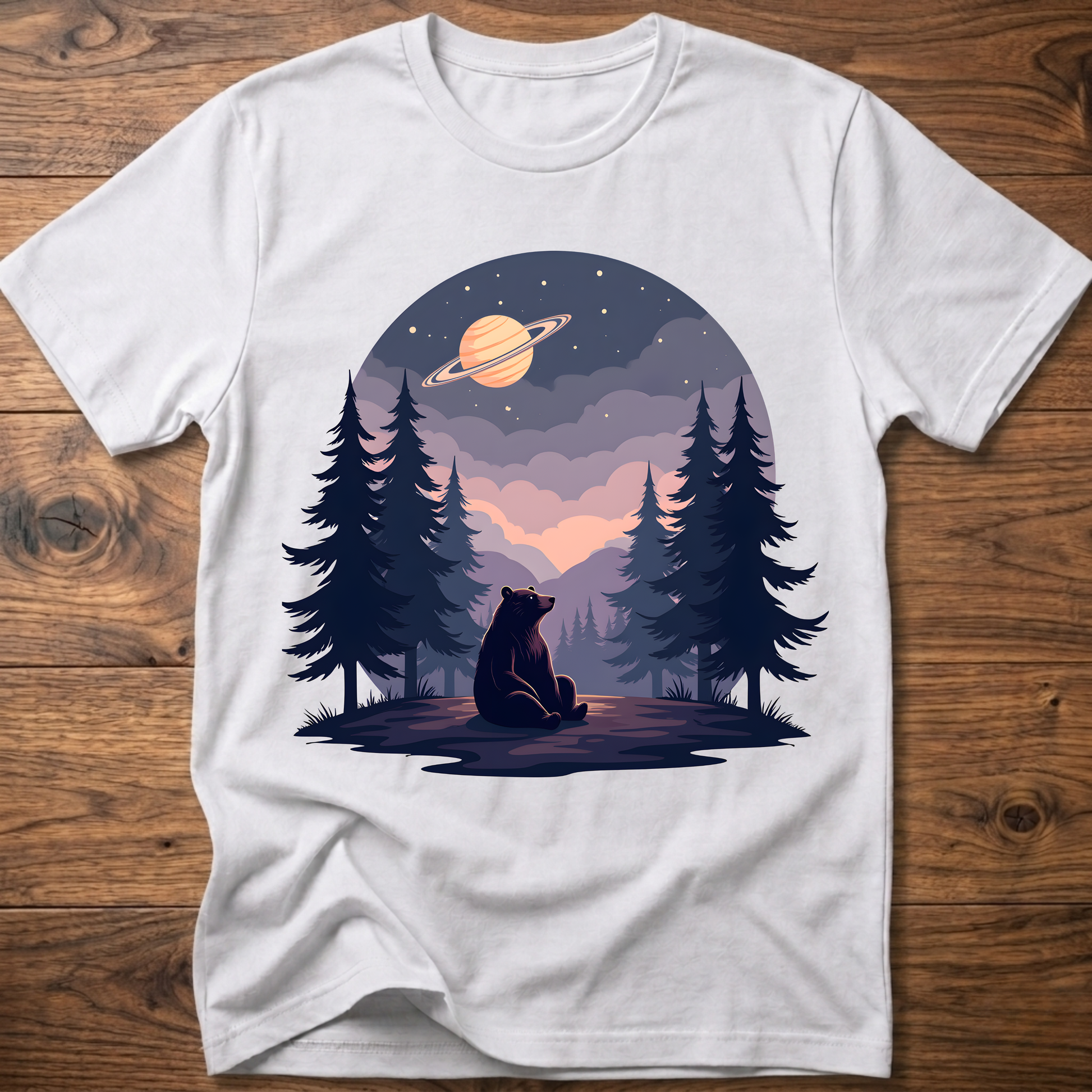 White t-shirt with night sky bear graphic, planet ring and pine trees on front