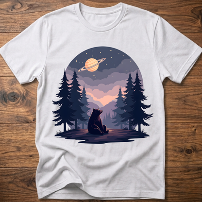White t-shirt with night sky bear graphic, planet ring and pine trees on front