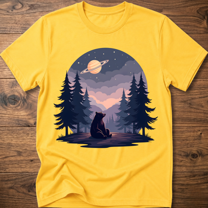 Yellow t-shirt with night sky bear graphic, ringed planet and pine trees on front