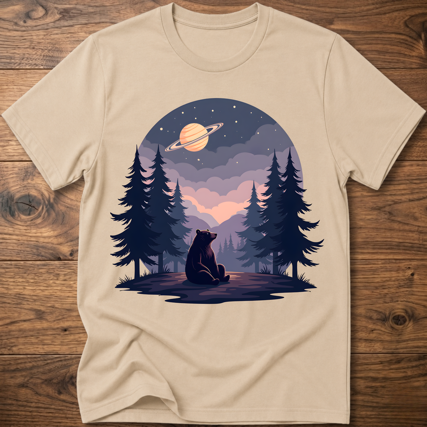 Sand t-shirt with night sky bear graphic, ringed planet and pine trees on front