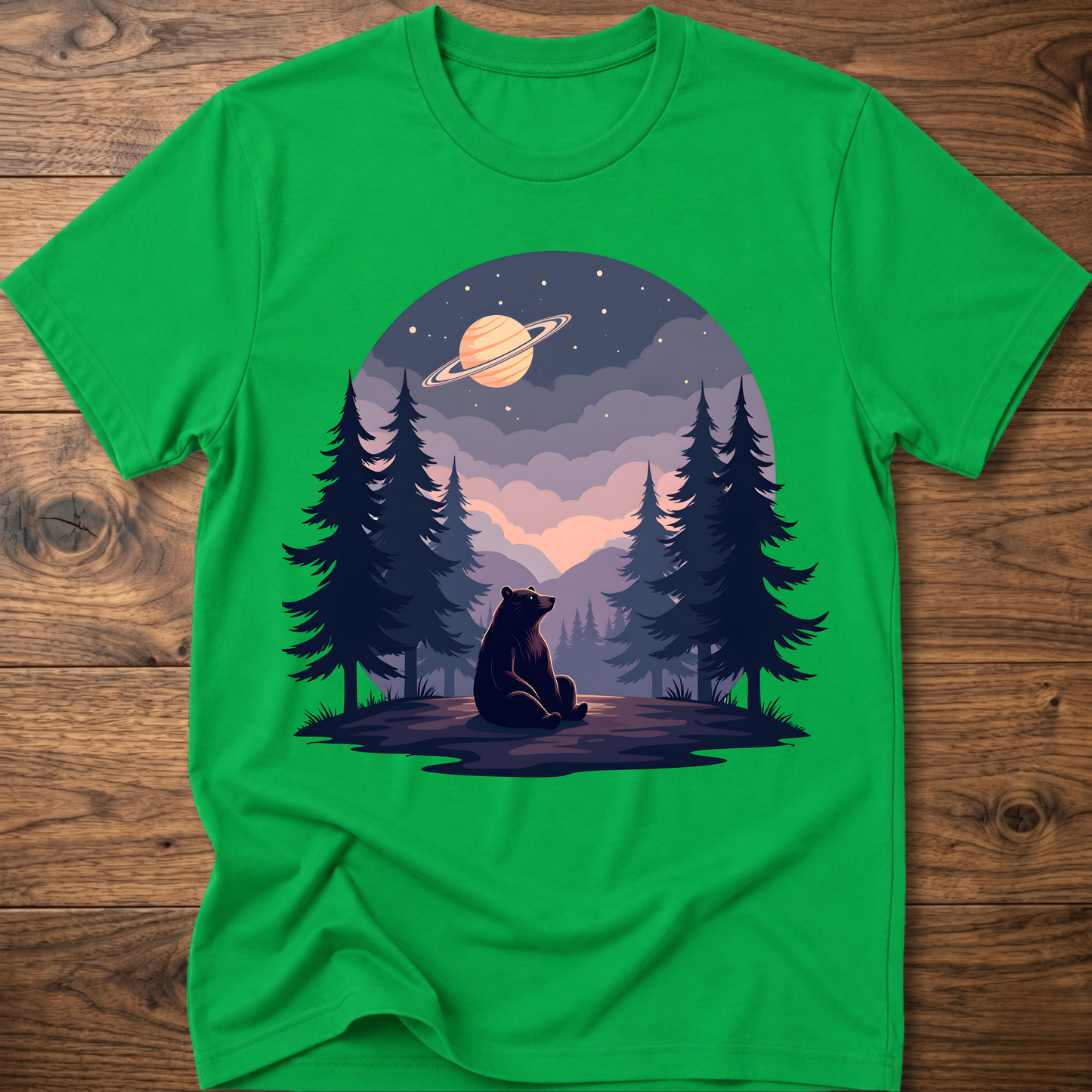 Bright green t-shirt with night sky bear graphic, ringed planet and pine trees