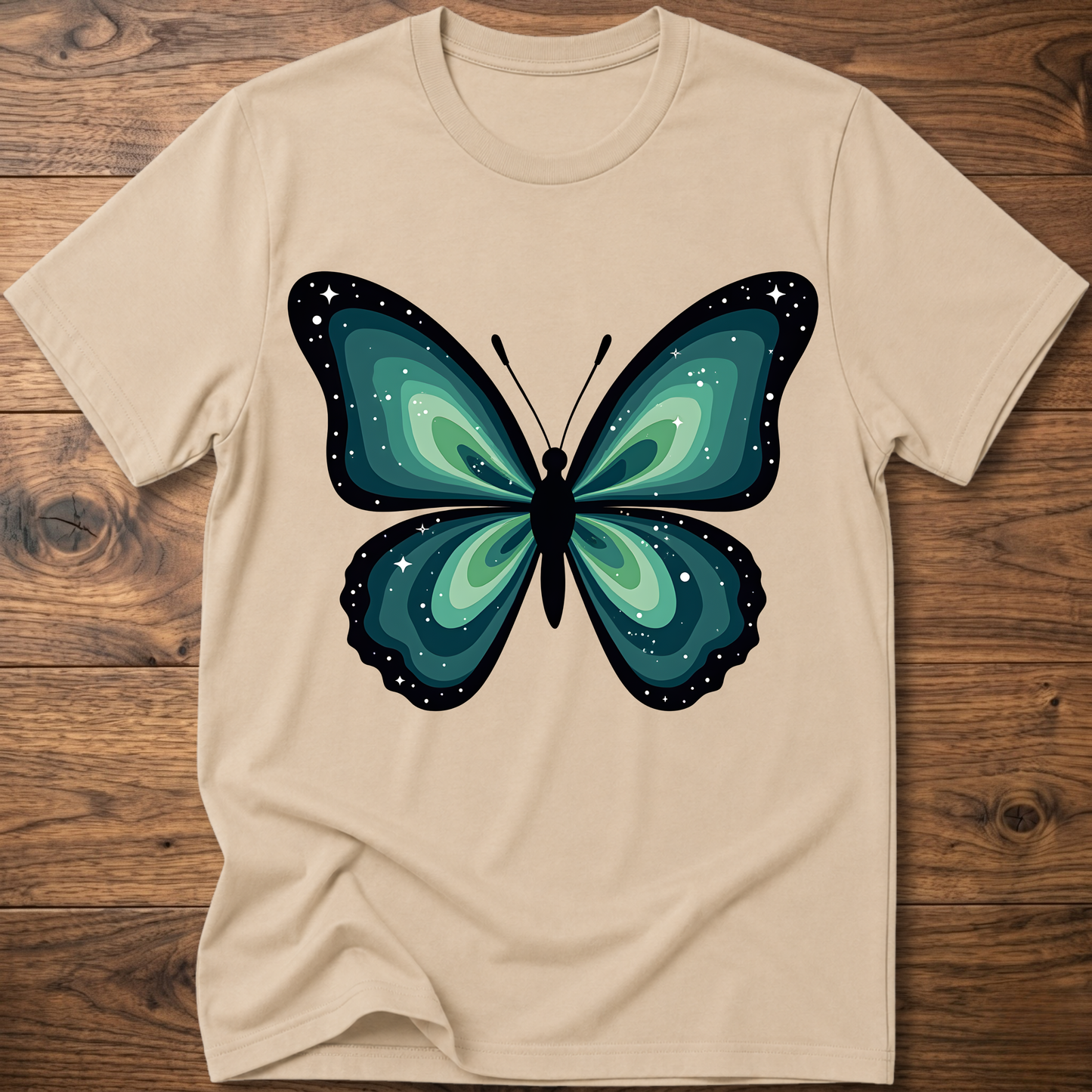 Sand t-shirt with teal butterfly graphic in navy outline, crew neck.