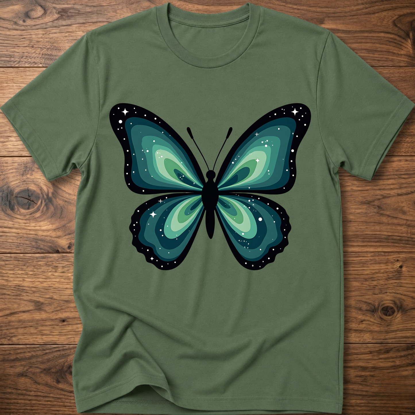 Green t-shirt with teal butterfly graphic in navy outline, crew neck.