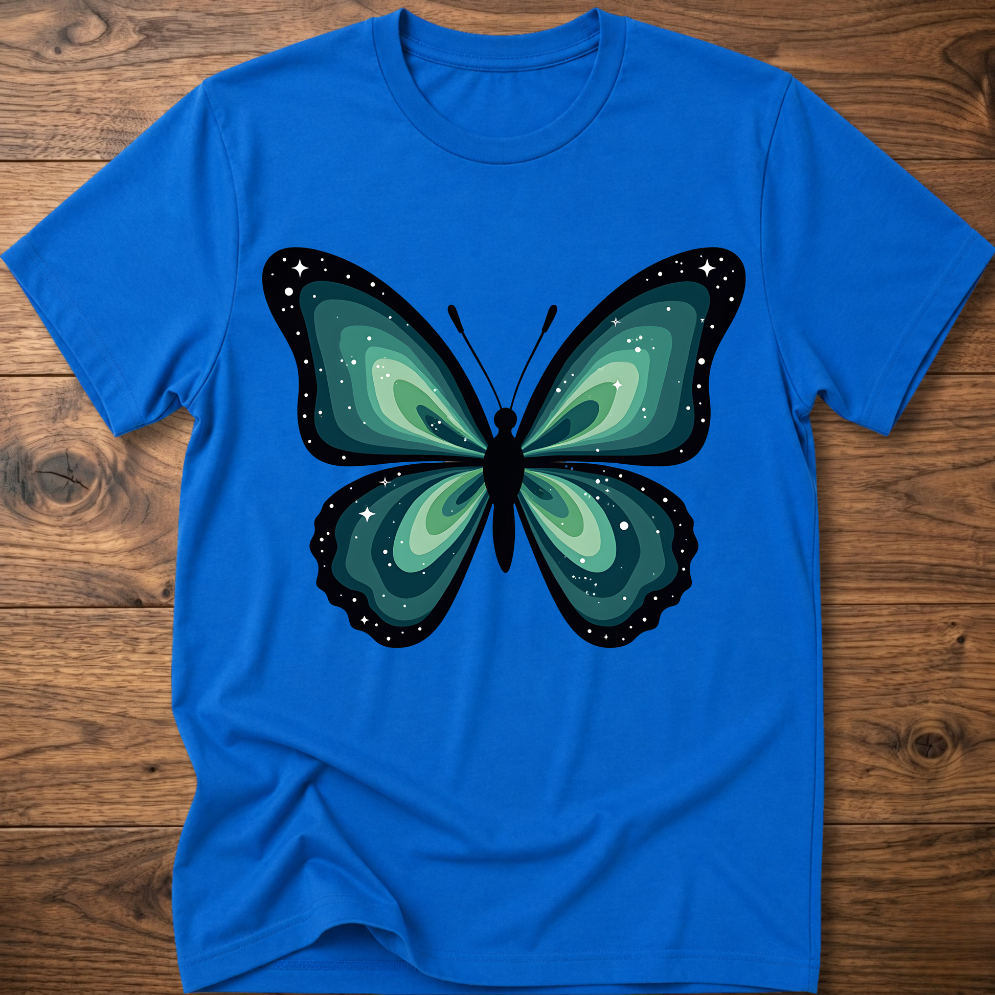 Royal blue t-shirt with teal butterfly graphic in navy outline, crew neck.