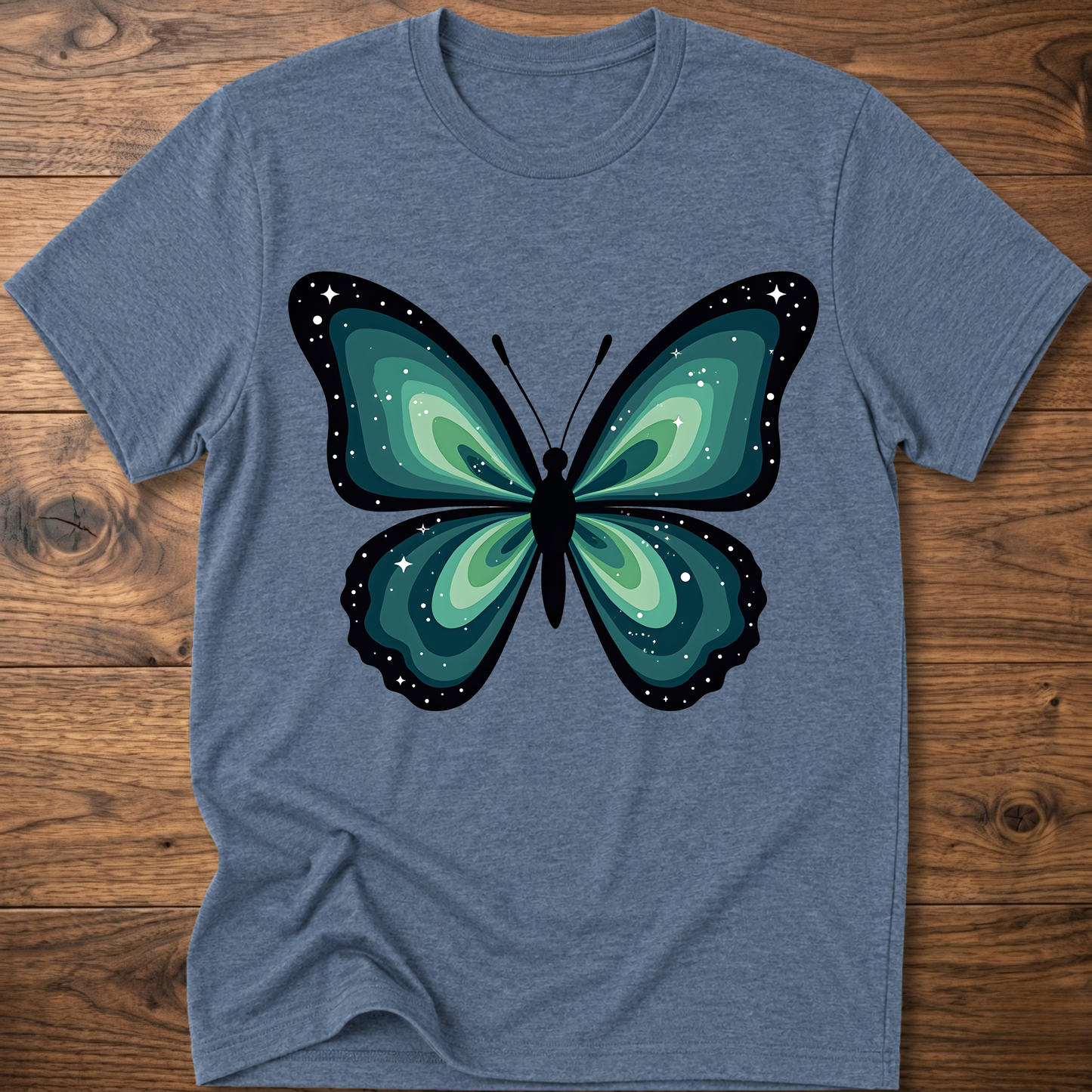 Blue-gray t-shirt with teal butterfly graphic in navy outline, crew neck.