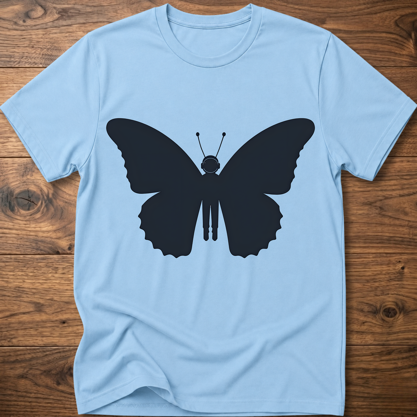 Light blue crewneck T-shirt with dark blue astronaut butterfly graphic on the front