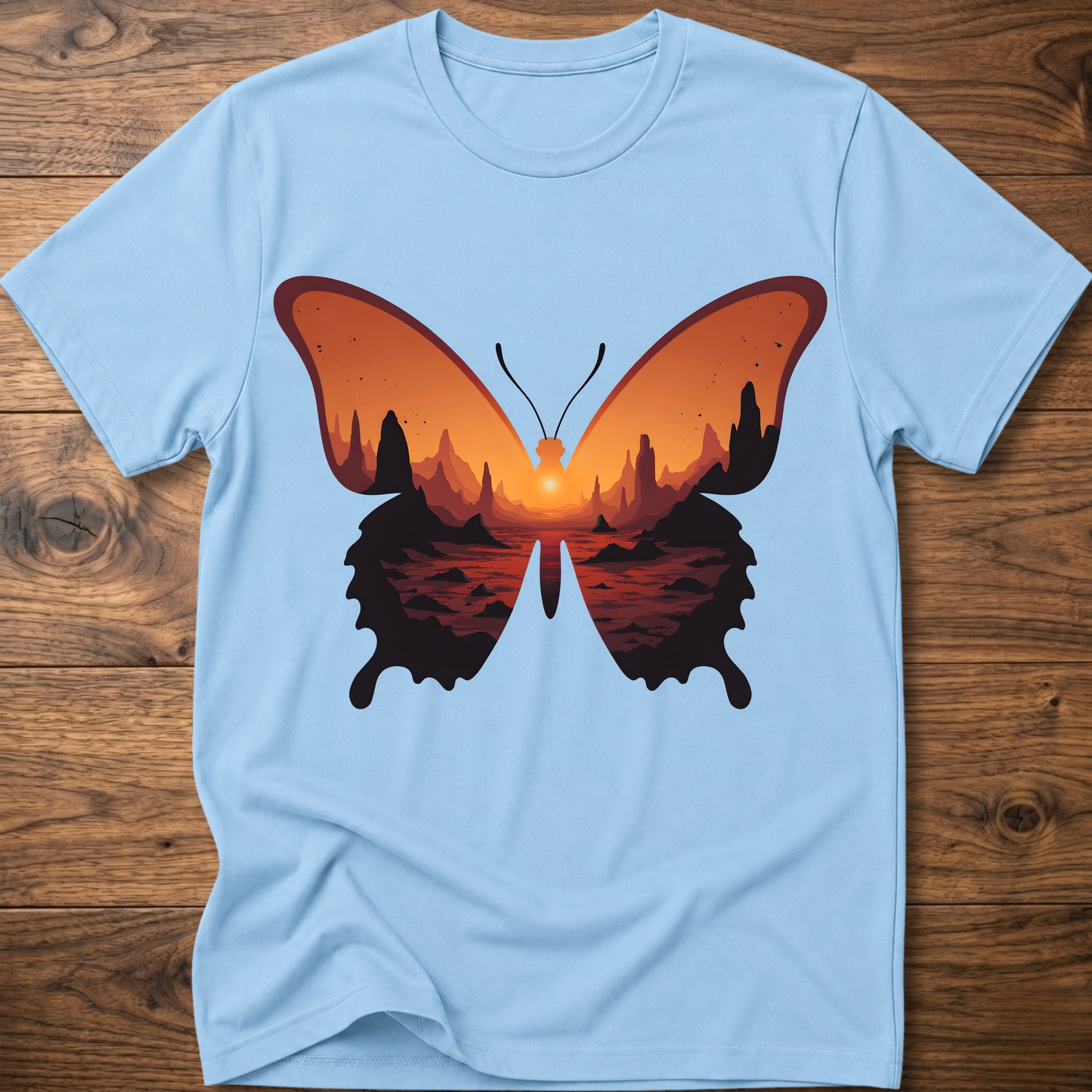 Light blue crew-neck T-shirt with colorful butterfly graphic in orange and black