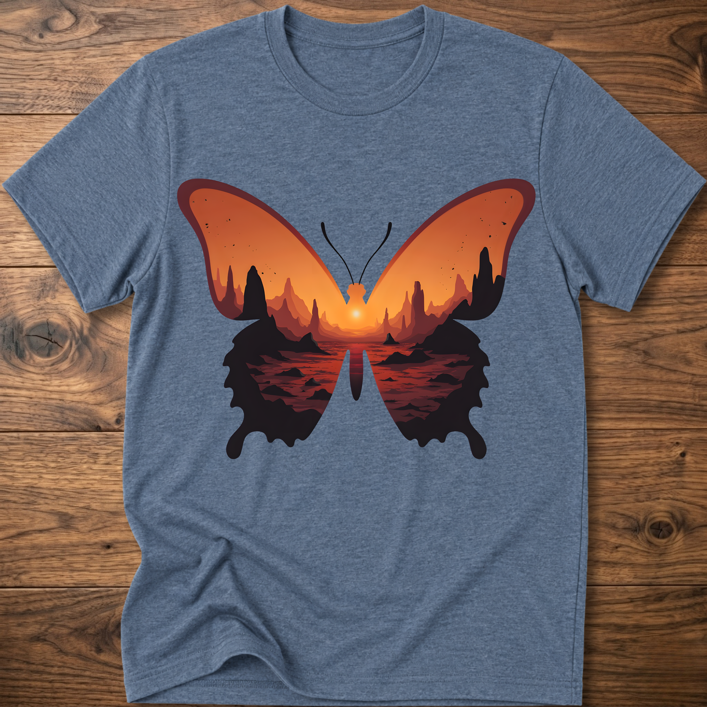 Light blue crew-neck T-shirt with colorful butterfly graphic in orange and black