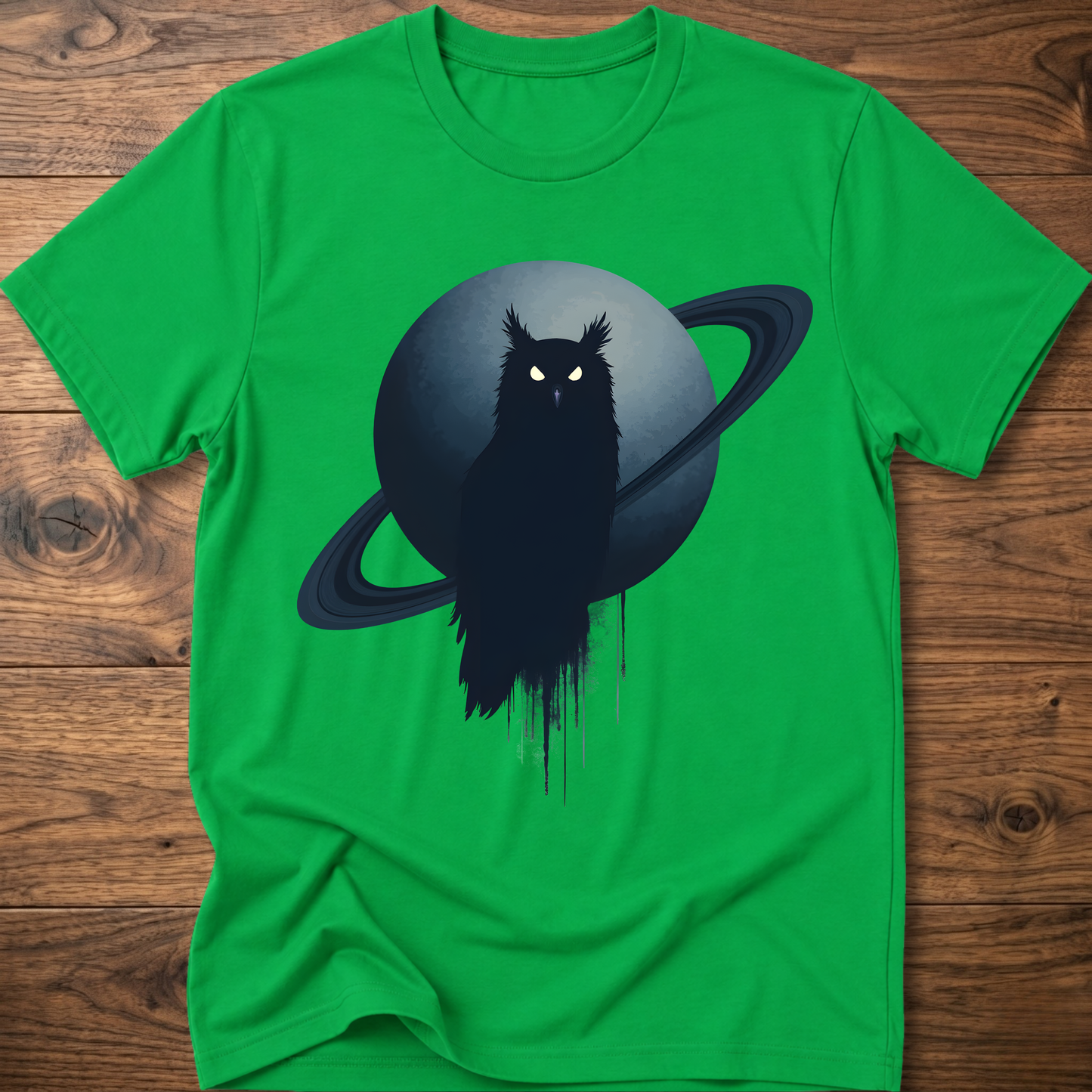 Green t-shirt with black owl and Saturn graphic print on the front