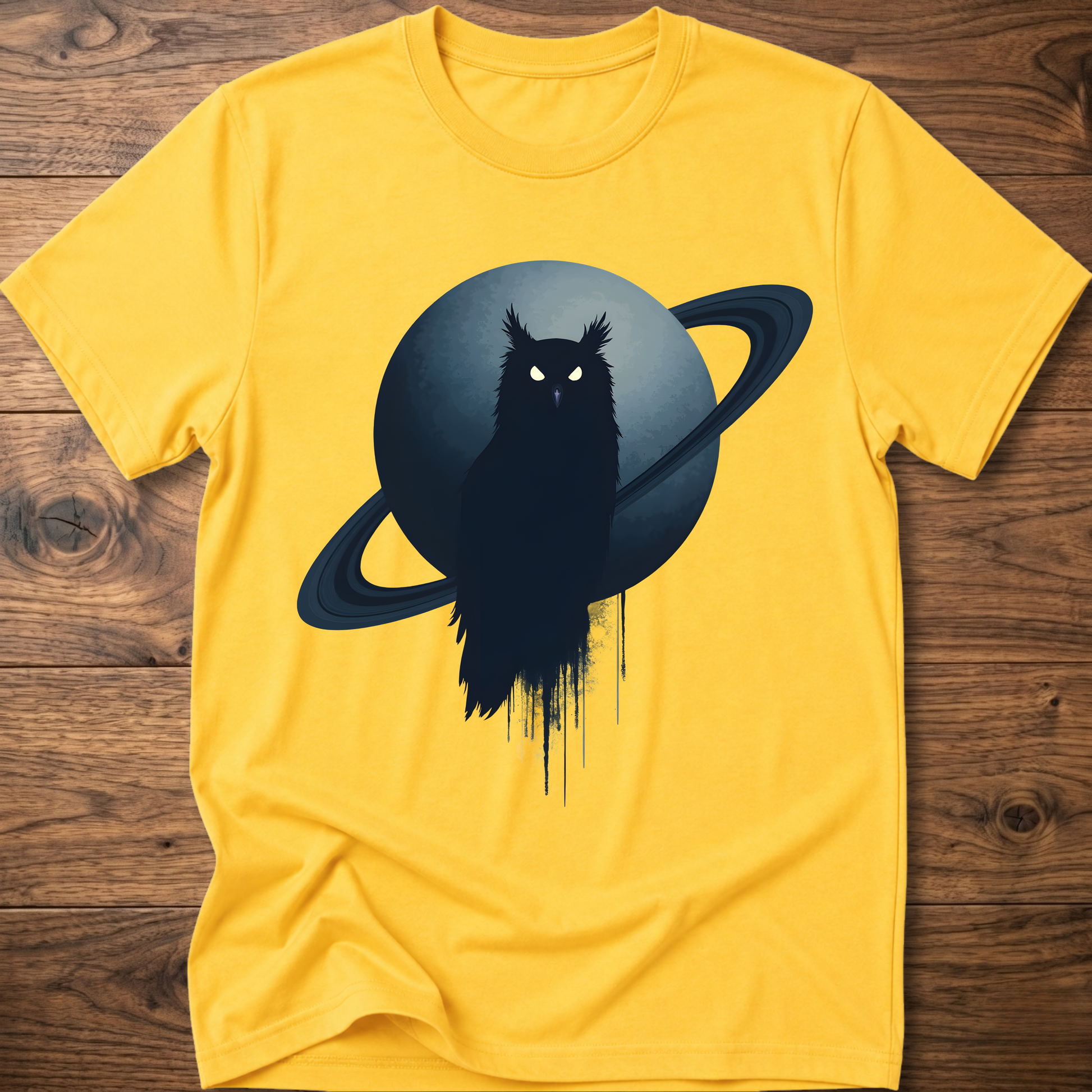 Yellow t-shirt with black owl and Saturn graphic print on the front