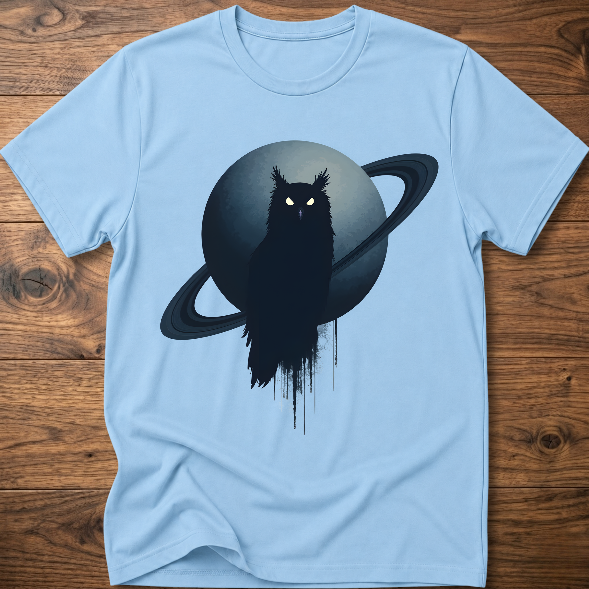 Light blue t-shirt with black owl and Saturn graphic print on the front