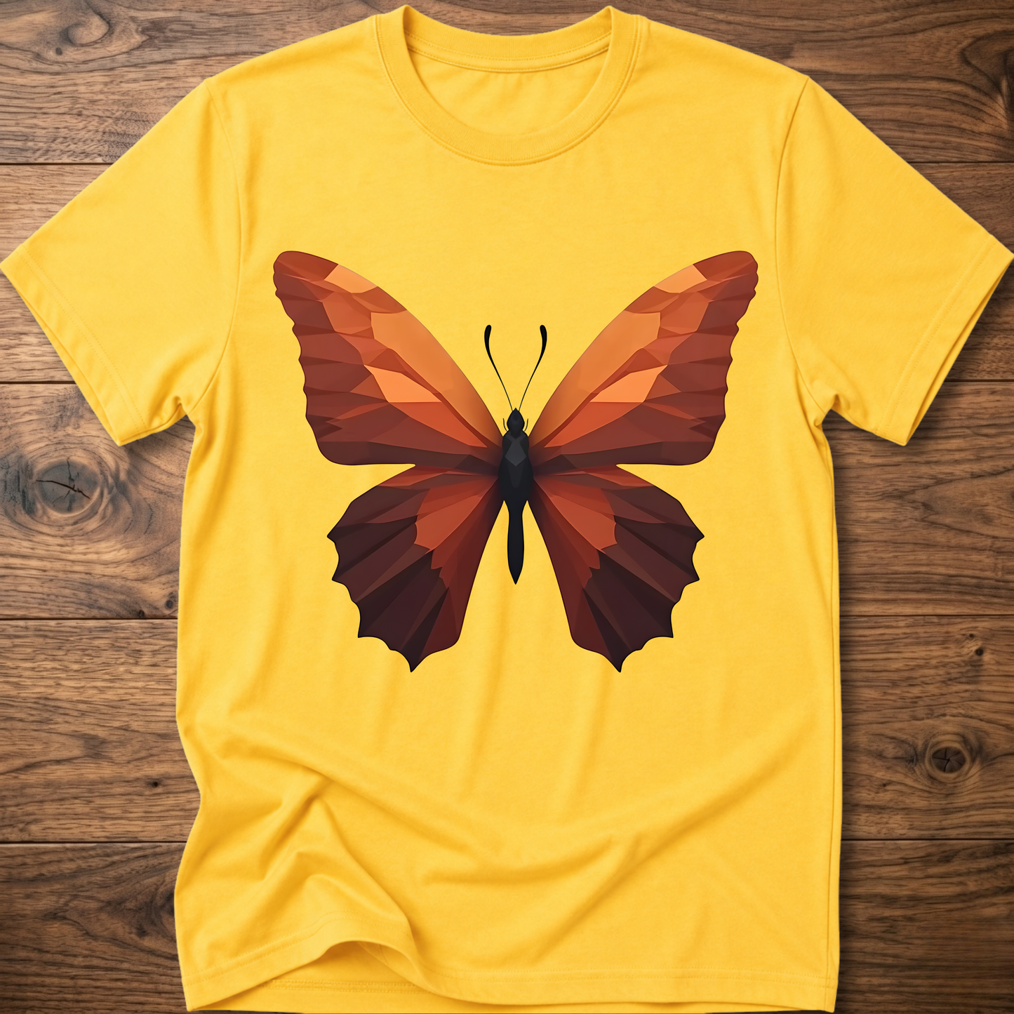 Yellow T-shirt with geometric butterfly graphic, orange and brown wings on front.