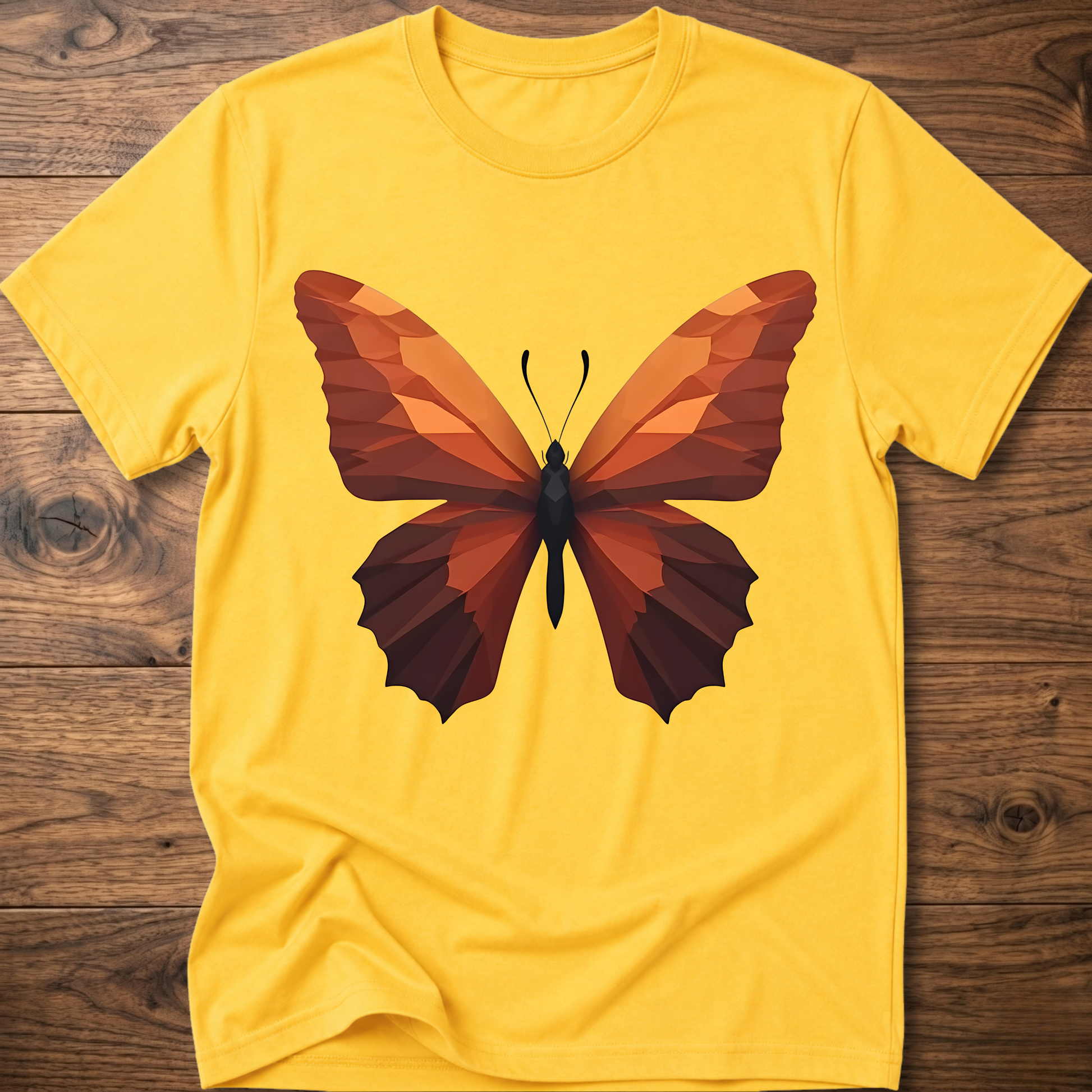 Yellow T-shirt with geometric butterfly graphic, orange and brown wings on front.
