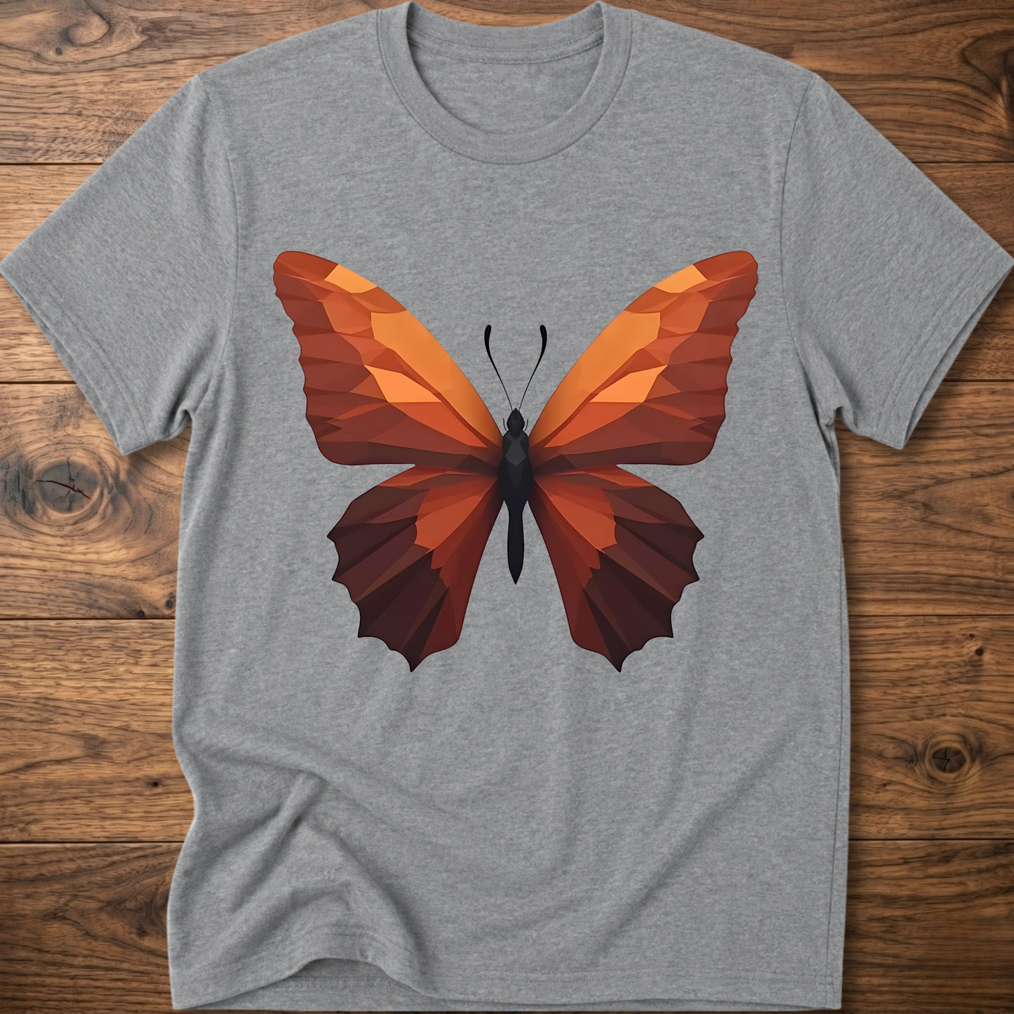 Heather gray T-shirt with geometric butterfly graphic, orange and brown wings on front.