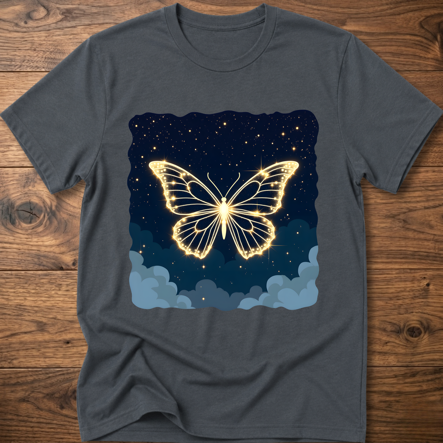 Gray-blue T-shirt with glowing butterfly graphic over starry night and clouds