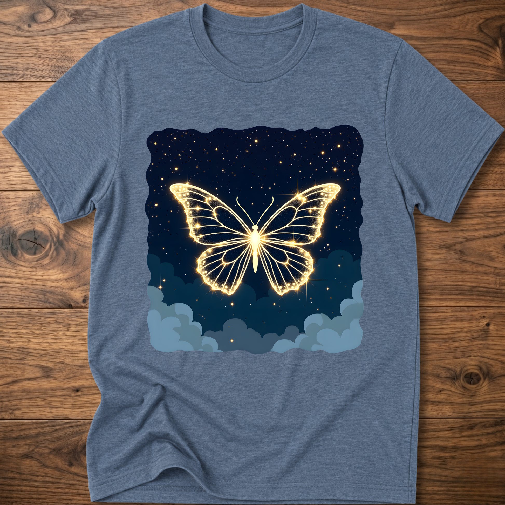 Heather blue T-shirt with glowing butterfly graphic over night sky and clouds