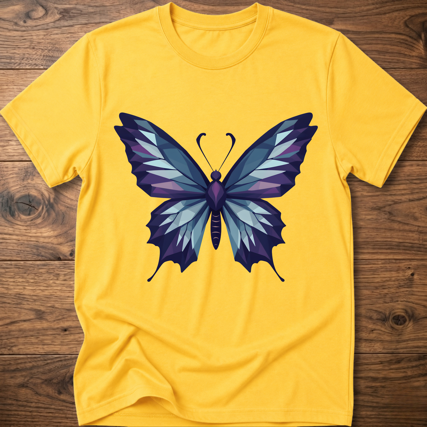 Yellow t-shirt with geometric butterfly graphic in blue and purple, crew neck.
