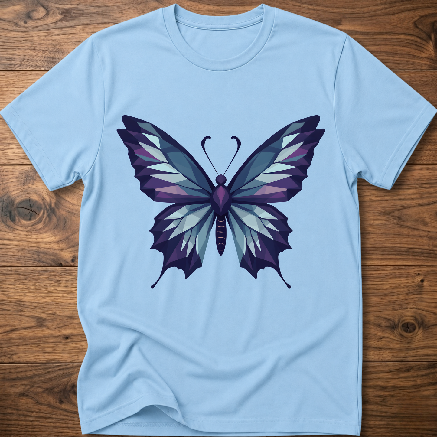 Light blue t-shirt with geometric butterfly graphic in blue and purple, crew neck.