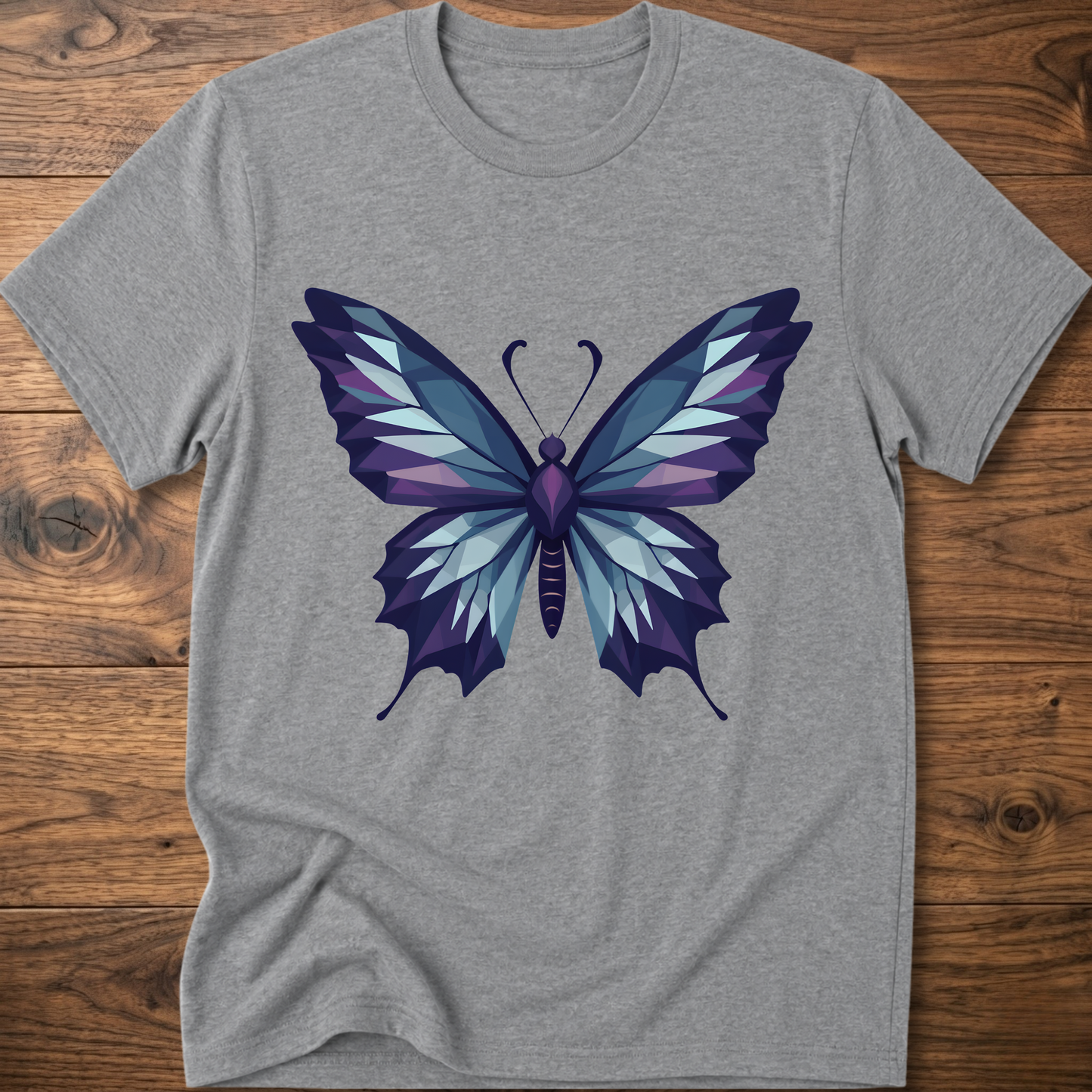 Gray t-shirt with geometric butterfly graphic in blue and purple, crew neck.