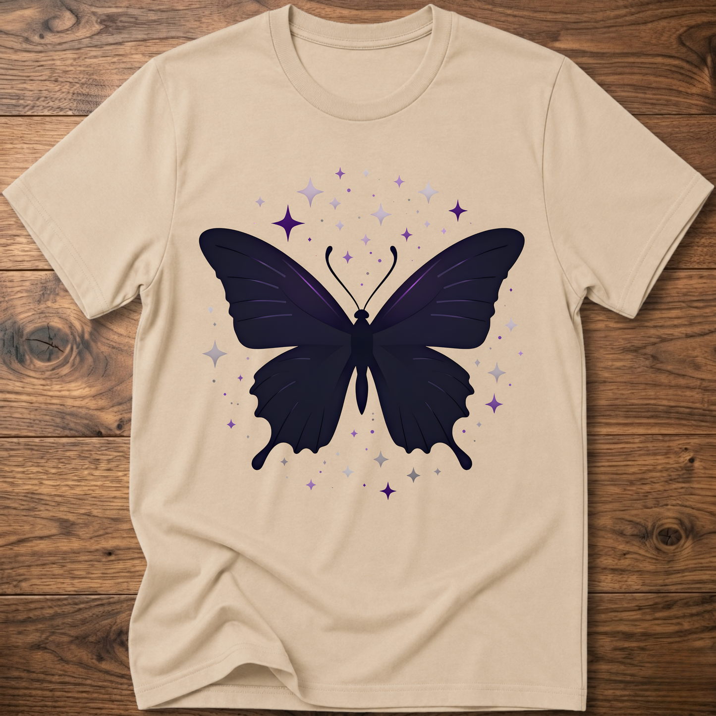 Beige T-shirt with dark butterfly star graphic in purple and gray