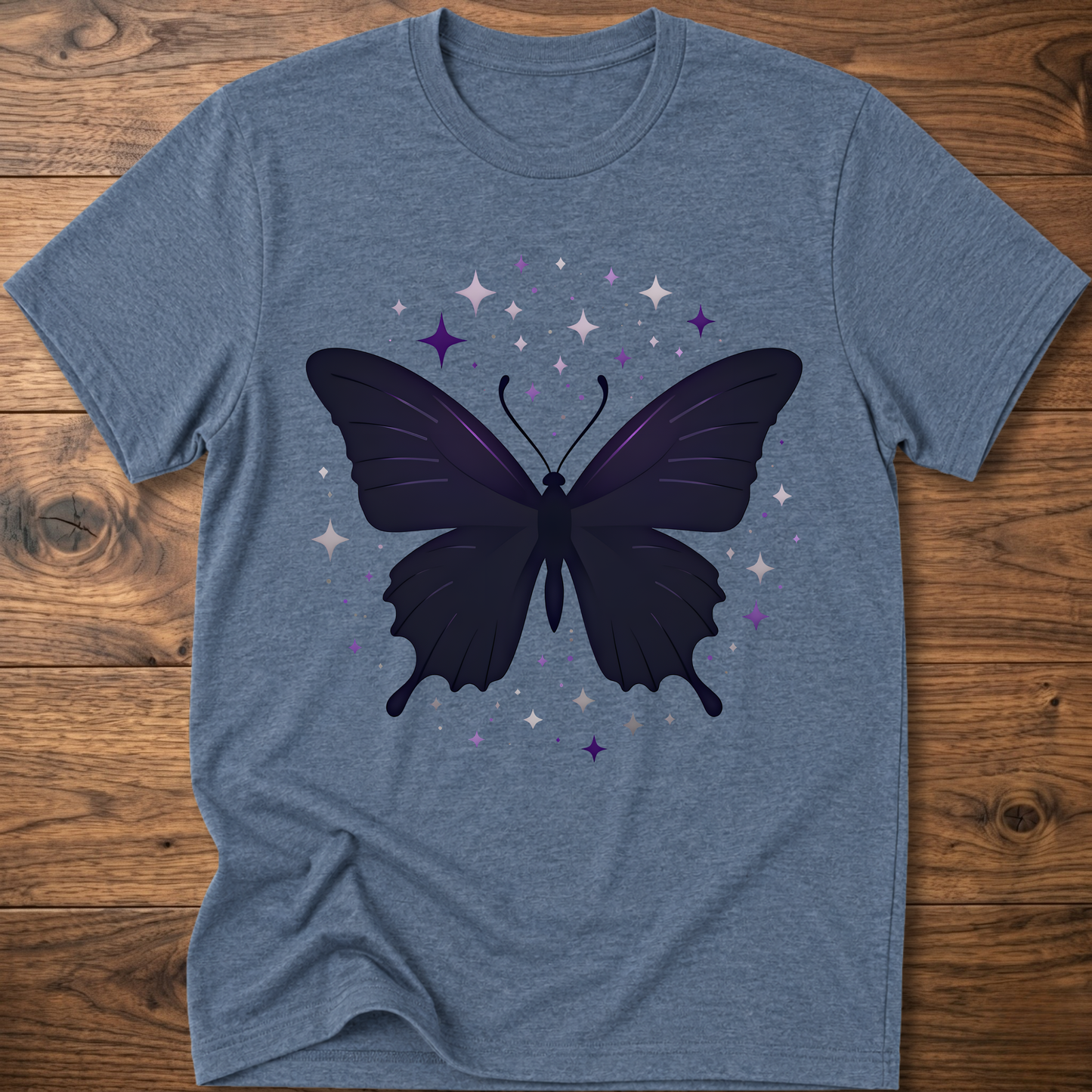 Blue-gray T-shirt with dark butterfly star graphic in purple and gray