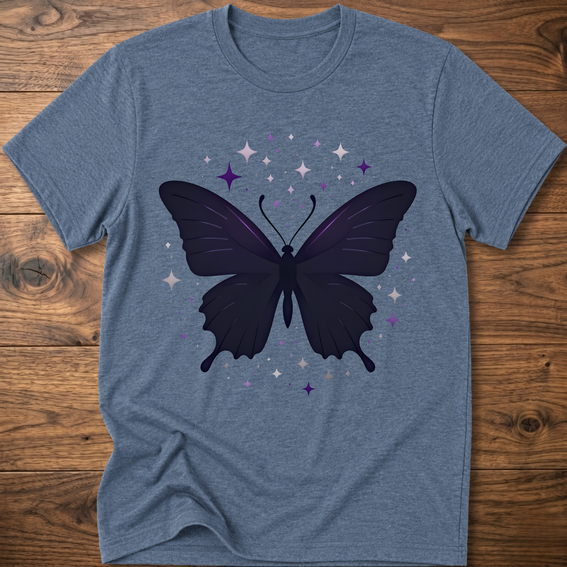 Blue-gray T-shirt with dark butterfly star graphic in purple and gray