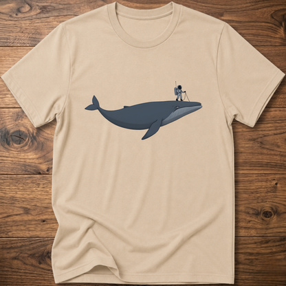 Beige astronaut whale T-shirt with graphic whale and astronaut standing on back fin