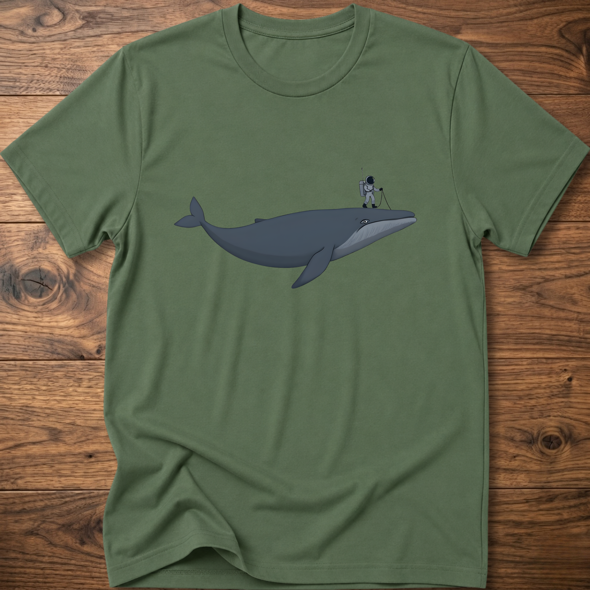 Green astronaut whale T-shirt with graphic whale and astronaut standing on back fin