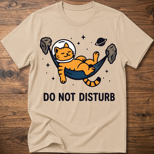 Graphic T-shirt in sand with cat astronaut and “DO NOT DISTURB” print