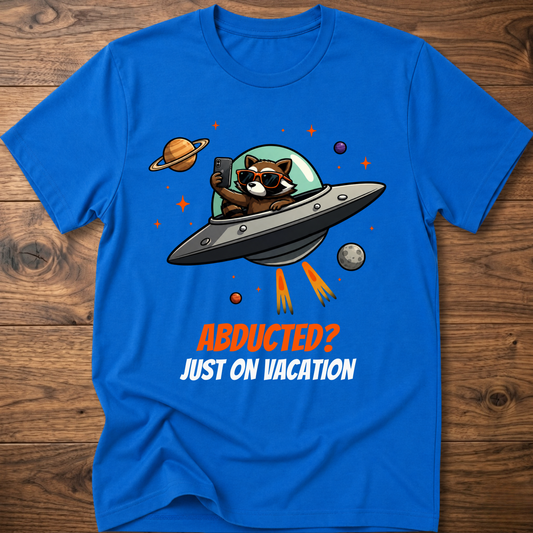 Royal blue t-shirt with space raccoon graphic and “Abducted? Just on Vacation” text